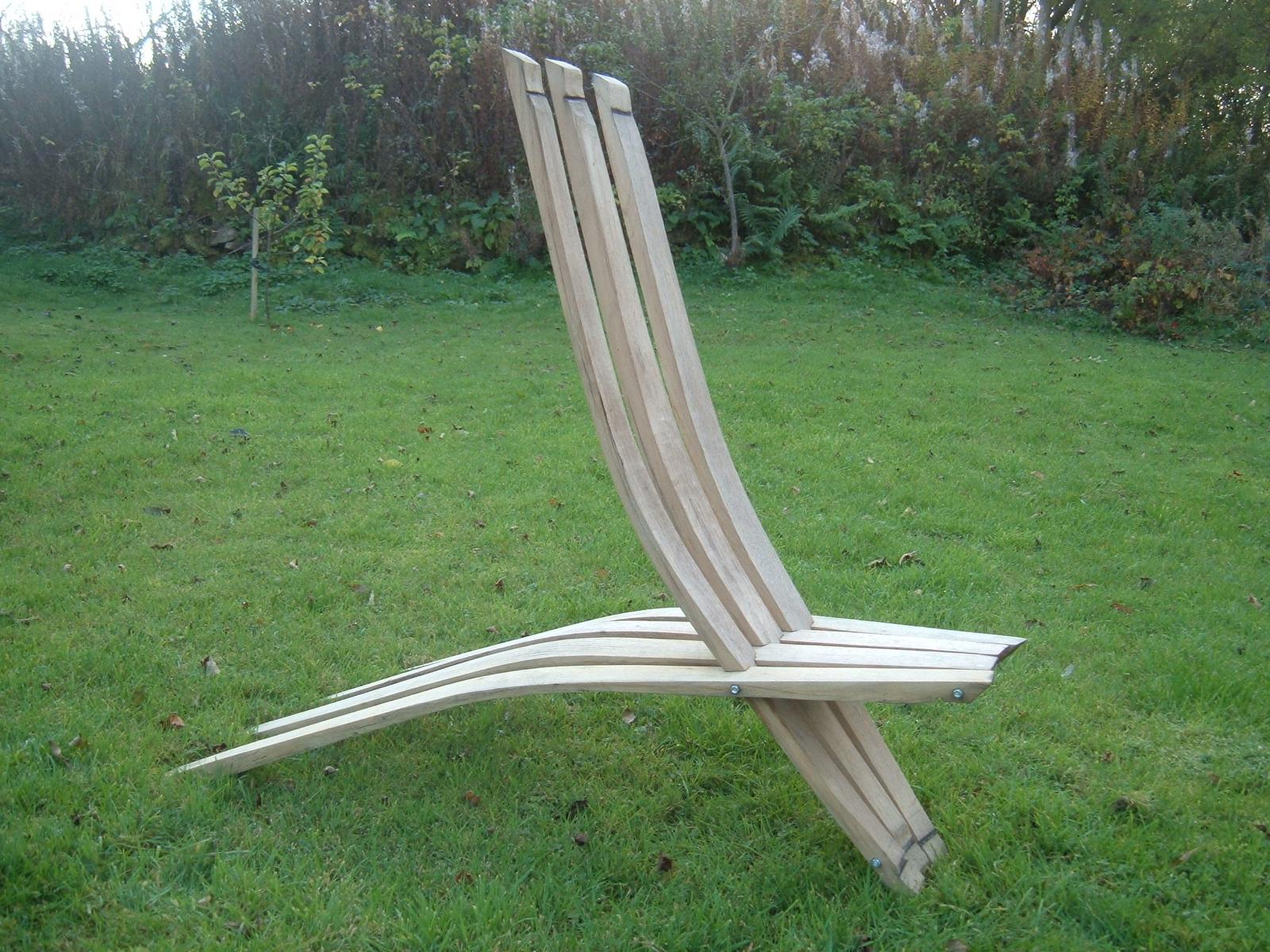 A handmade chair made from reclaimed whisky barrel staves standing on grass