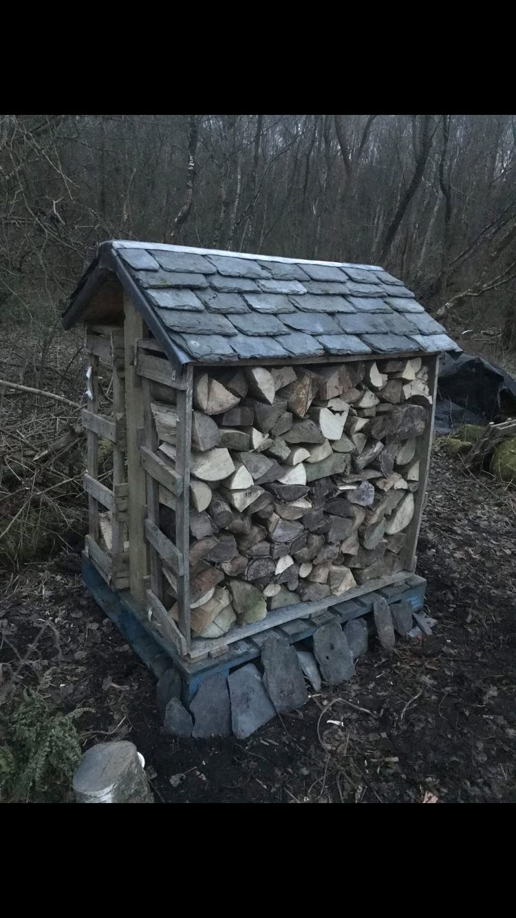 Log store made from fly-tipped slate and pallet wood